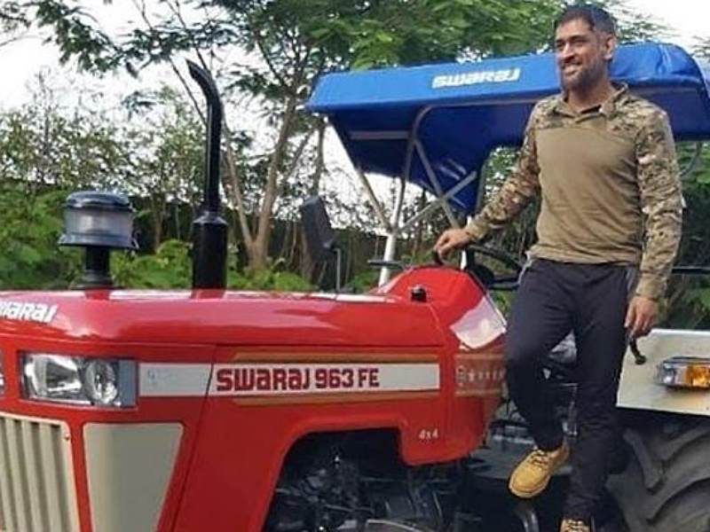 Dhoni at his farmhouse while driving tractor Dhoni at his farmhouse while driving tractor